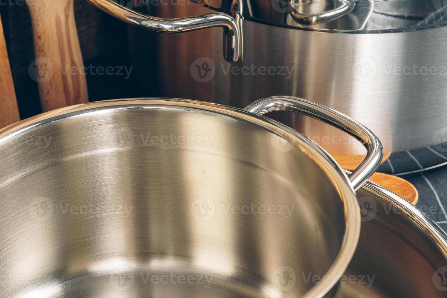 Set of stainless steel saucepans in a kitchen photo