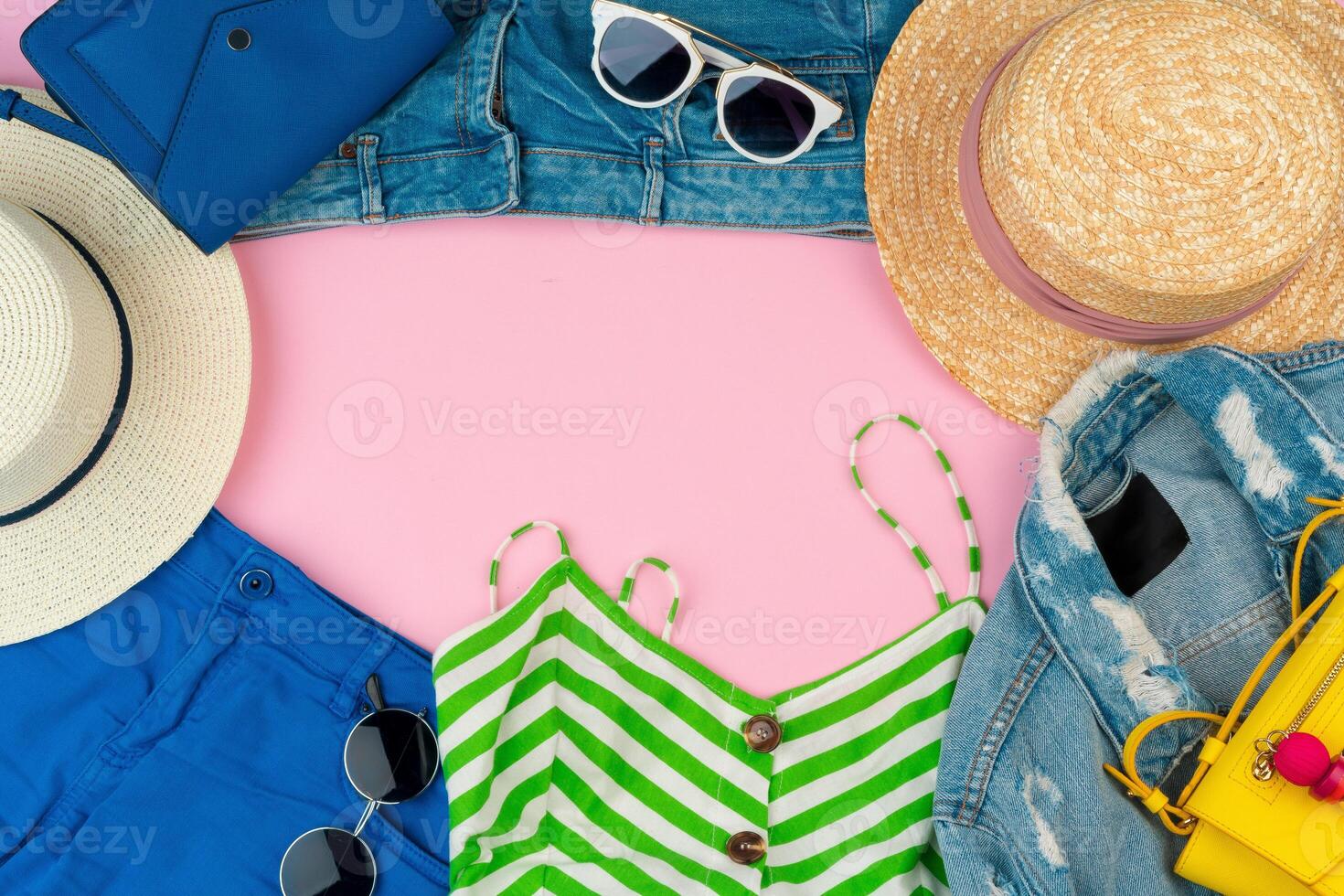 Set of summer clothes for woman on pink background photo