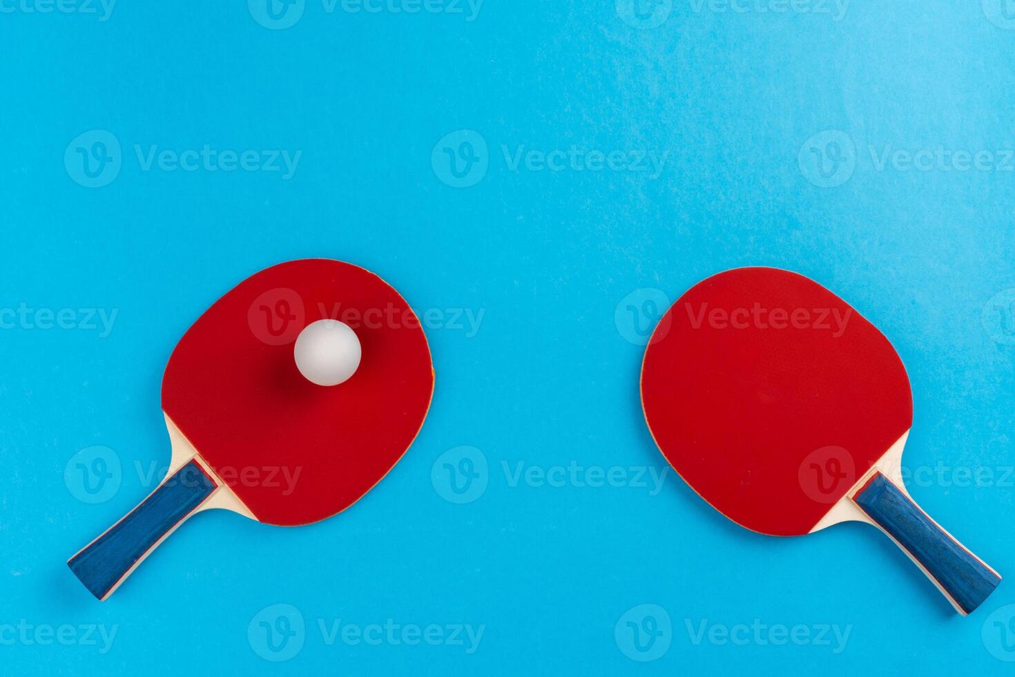 Ping pong racket and ball on blue background photo
