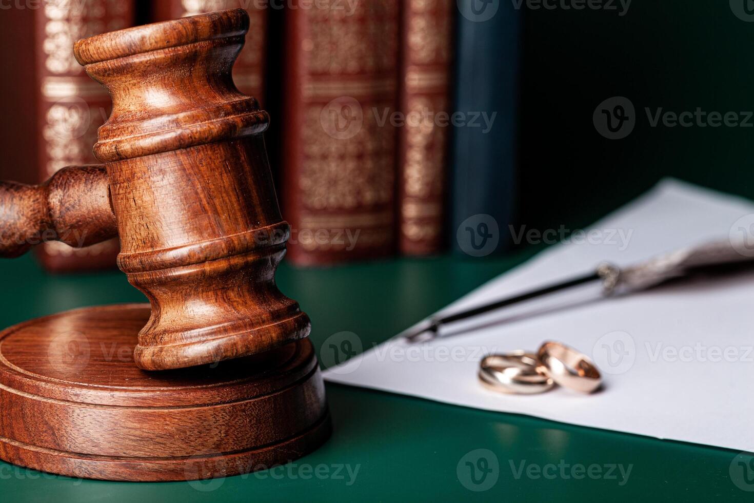 Law gavel and wedding rings on table photo