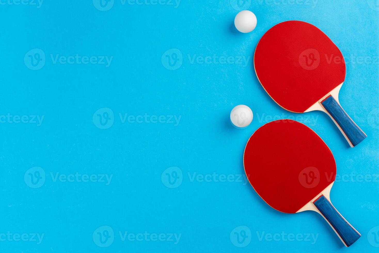 Ping pong racket and ball on blue background photo