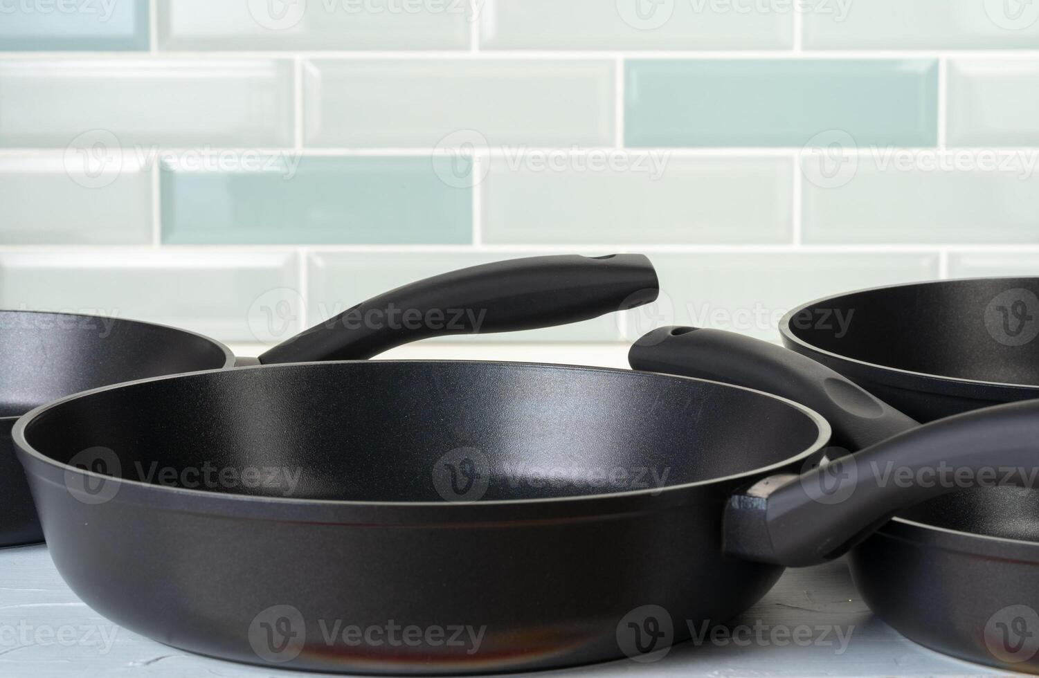 Clean and dry cooking pans on a kitchen counter photo