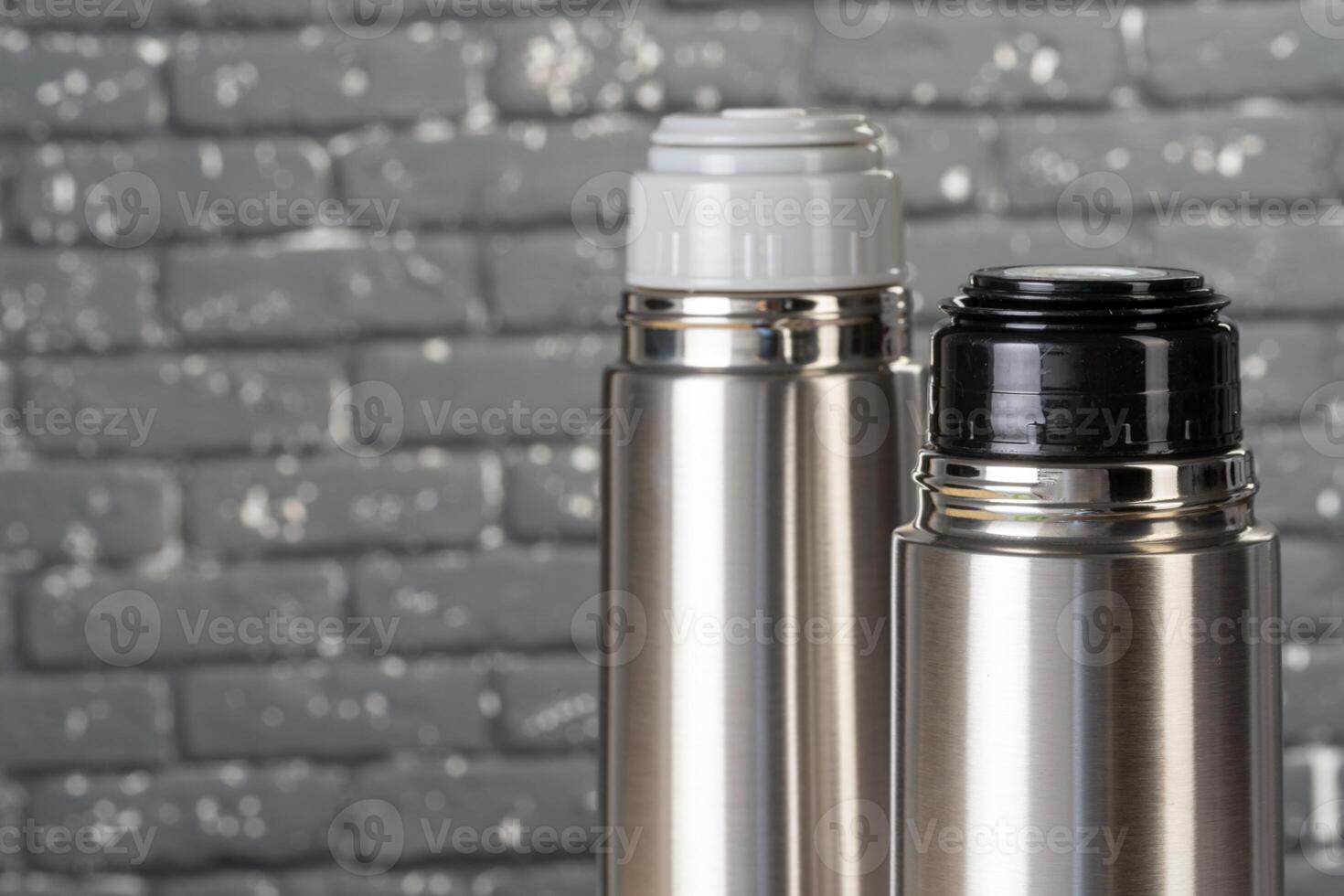 Aluminum metal thermos container bottle close up on table photo