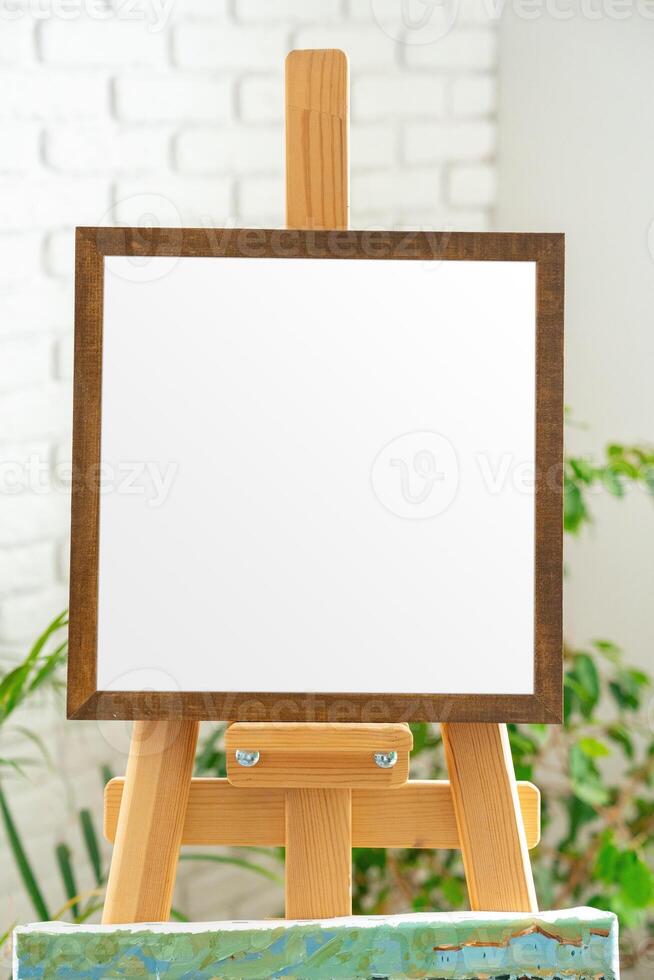 Blank canvas on easel ready for creative expression in bright indoor studio setting filled with natural light photo