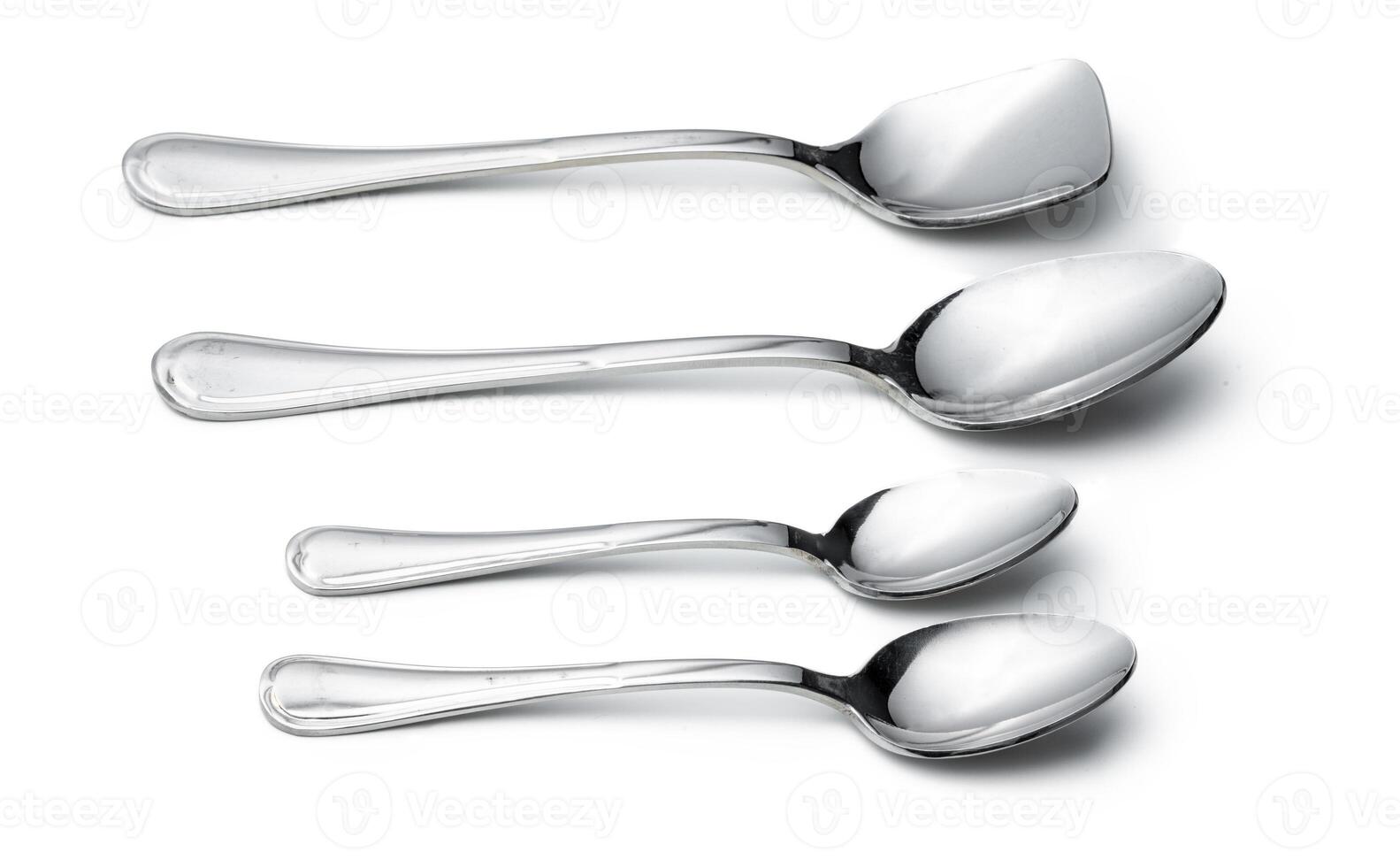 Silver shiny spoon isolated on white background photo