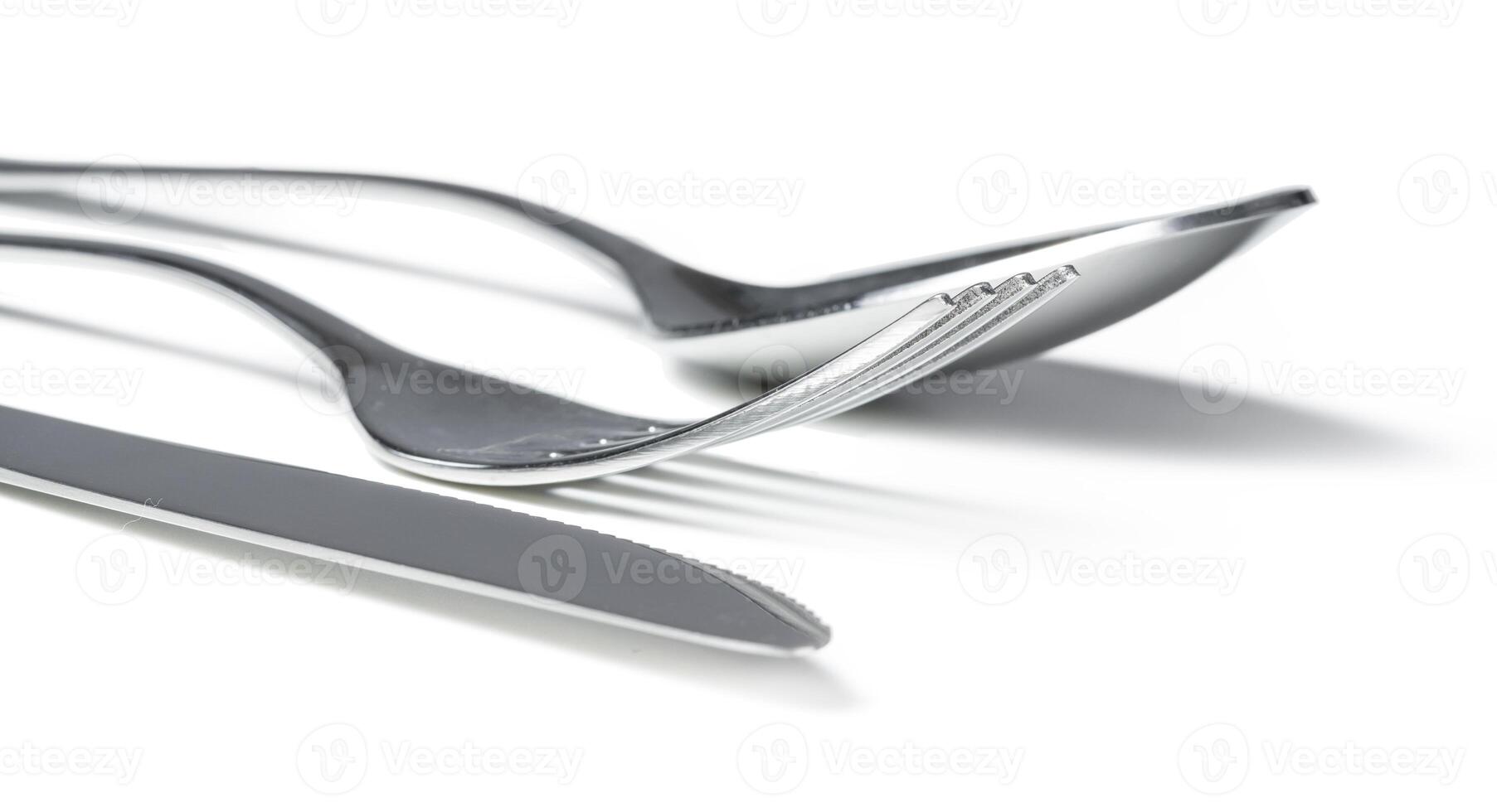 Spoon, knife and fork isolated on white background photo
