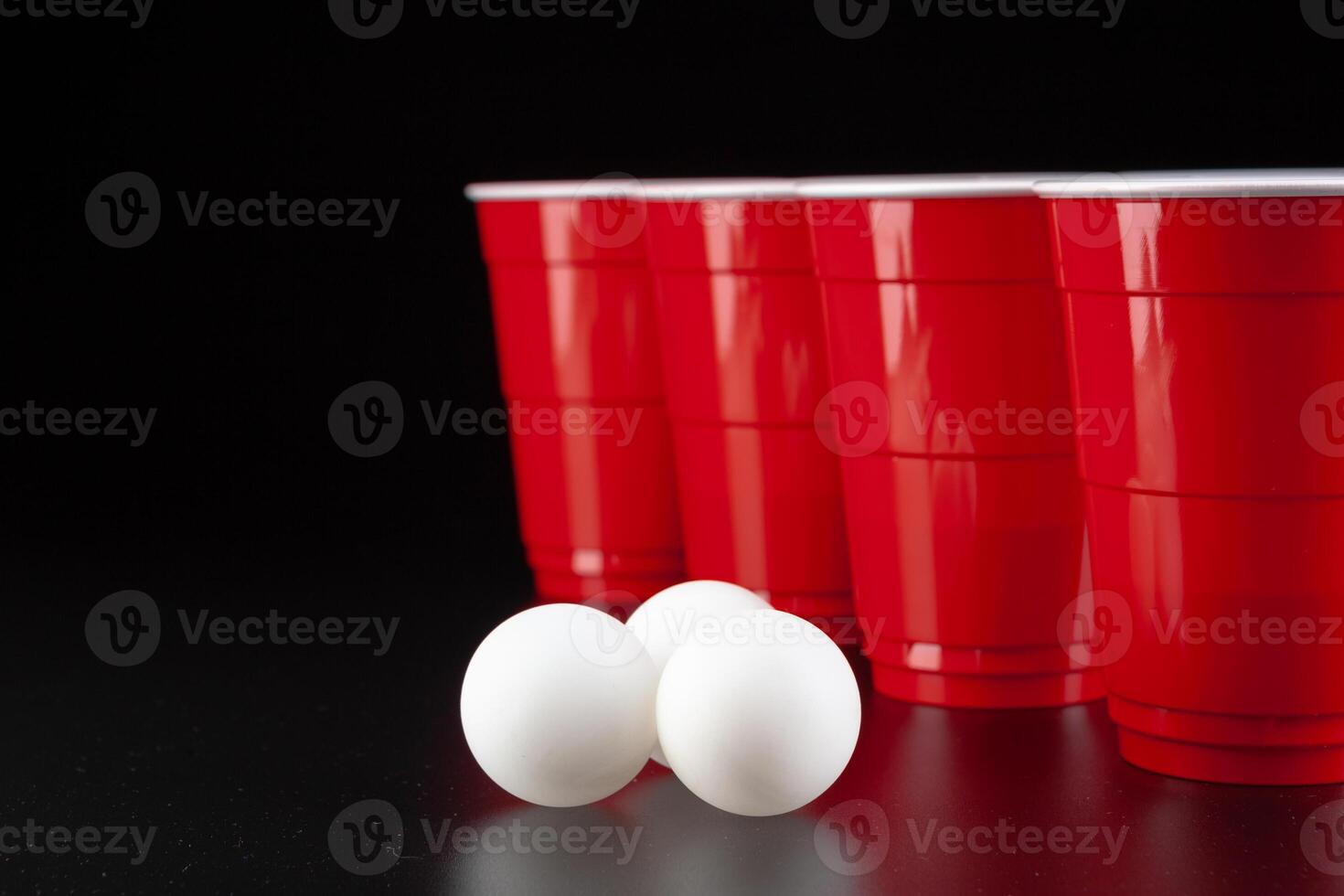 The arrangement of red plastic cups for game of beer pong photo