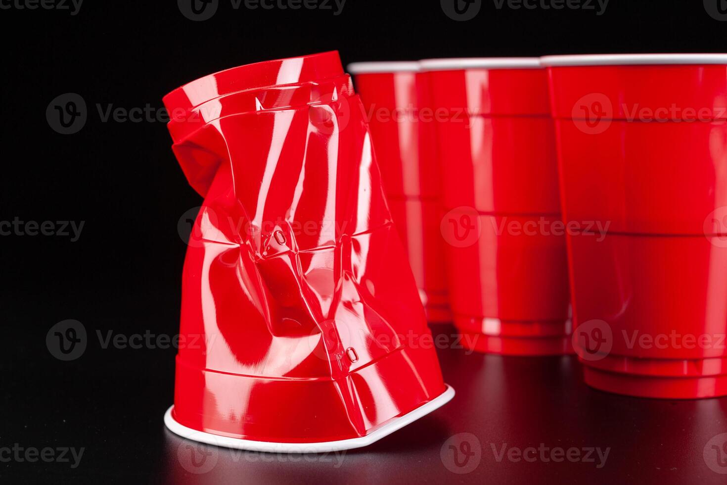 Red plastic cups and ball for game of beer pong photo