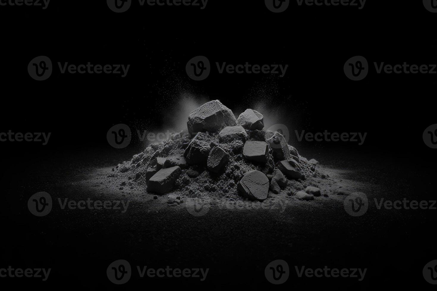 A pile of gray rocks and dust, illuminated from the front, with a black background photo