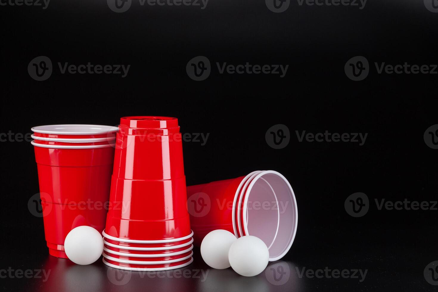 Red plastic cups and ball for game of beer pong photo