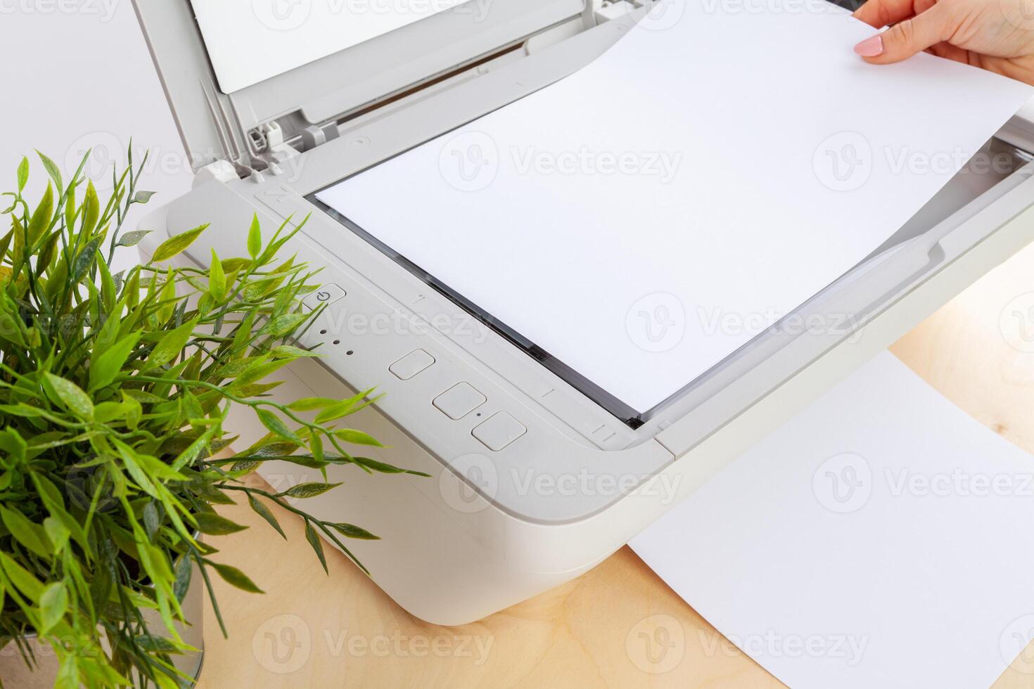Hands of a woman using a copying machine close up photo