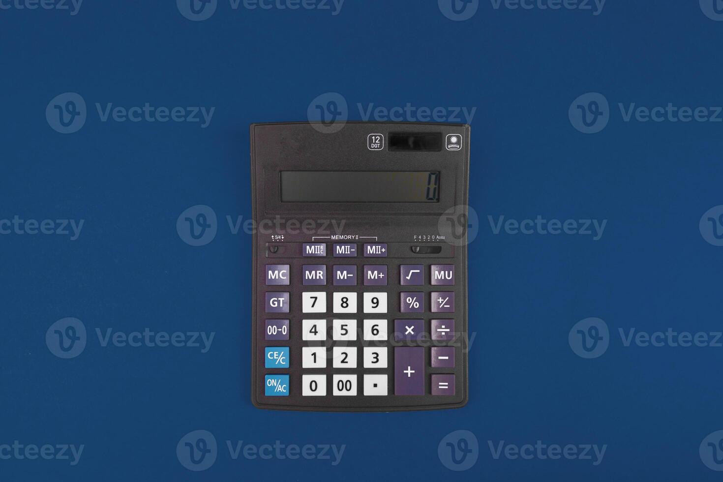 Top view of a calculator isolated on classic blue photo