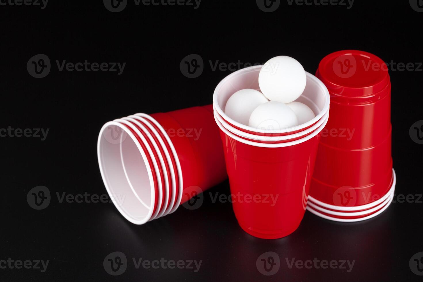 Red plastic cups and ball for game of beer pong photo
