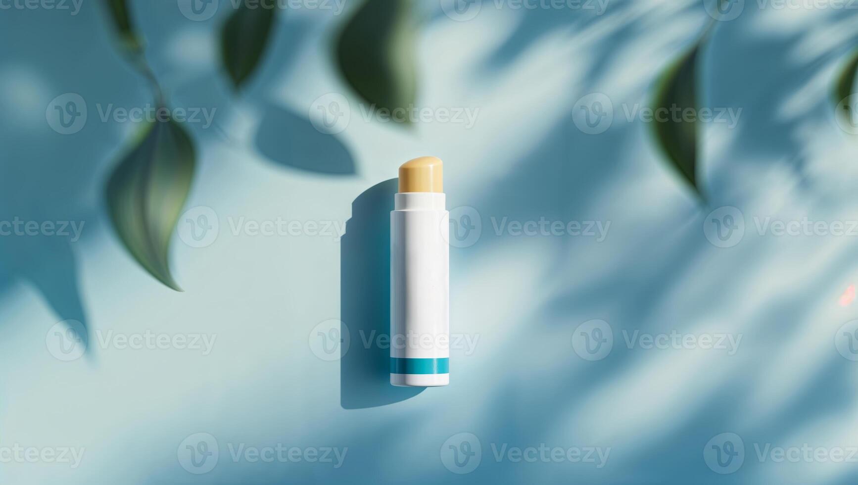 Lip balm placed on a blue surface with soft shadows and green leaves creating a calming atmosphere, showcasing beauty and self-care photo