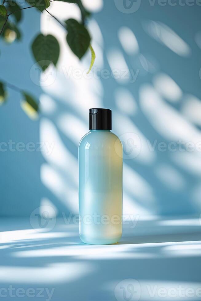 Clear bottle with liquid reflecting light in a serene setting decorated with subtle shadows and plants photo
