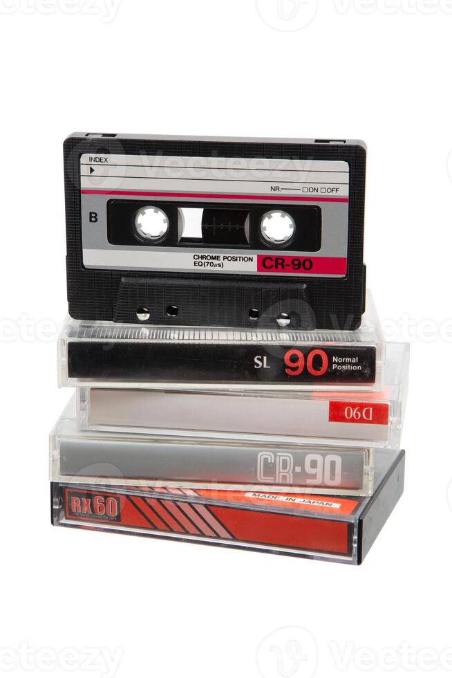 Stack of vintage audio cassettes, black and silver, in clear cases, retro 90s media, nostalgic tech. photo