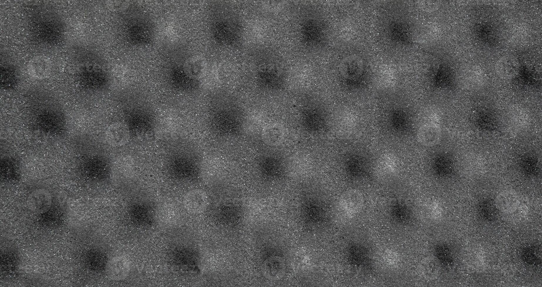 Acoustic foam panel in gray with an egg crate pattern, soundproofing material photo