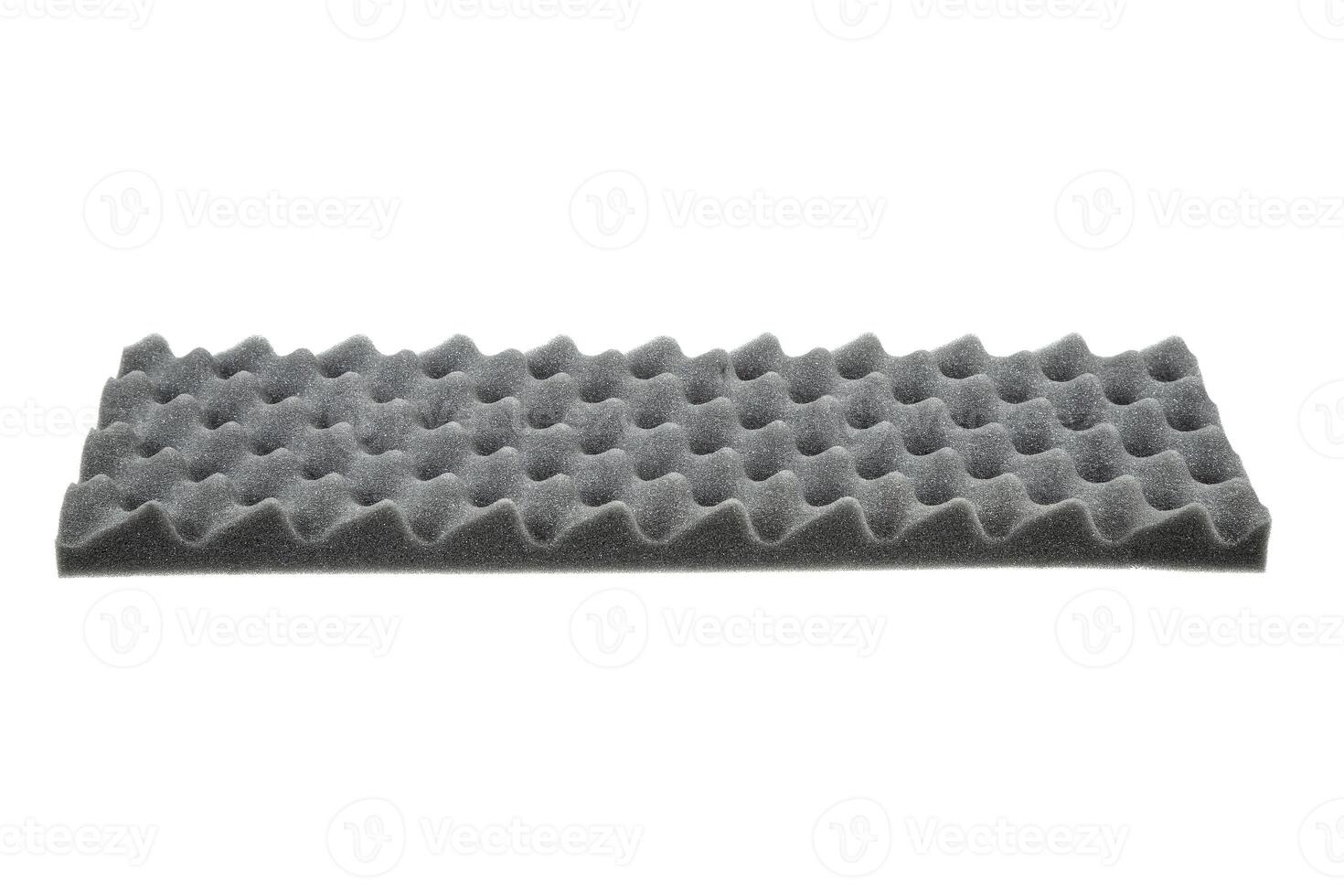 Isolated on a white background, this gray acoustic foam panel features an egg crate pattern for soundproofing. photo