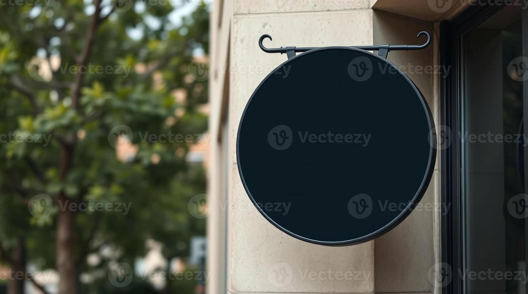A black round sign on the side of a building photo