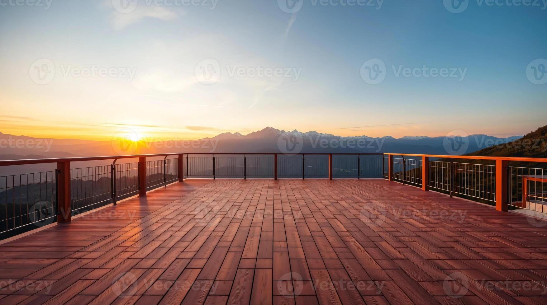 A wooden deck overlooking the mountains at sunset photo