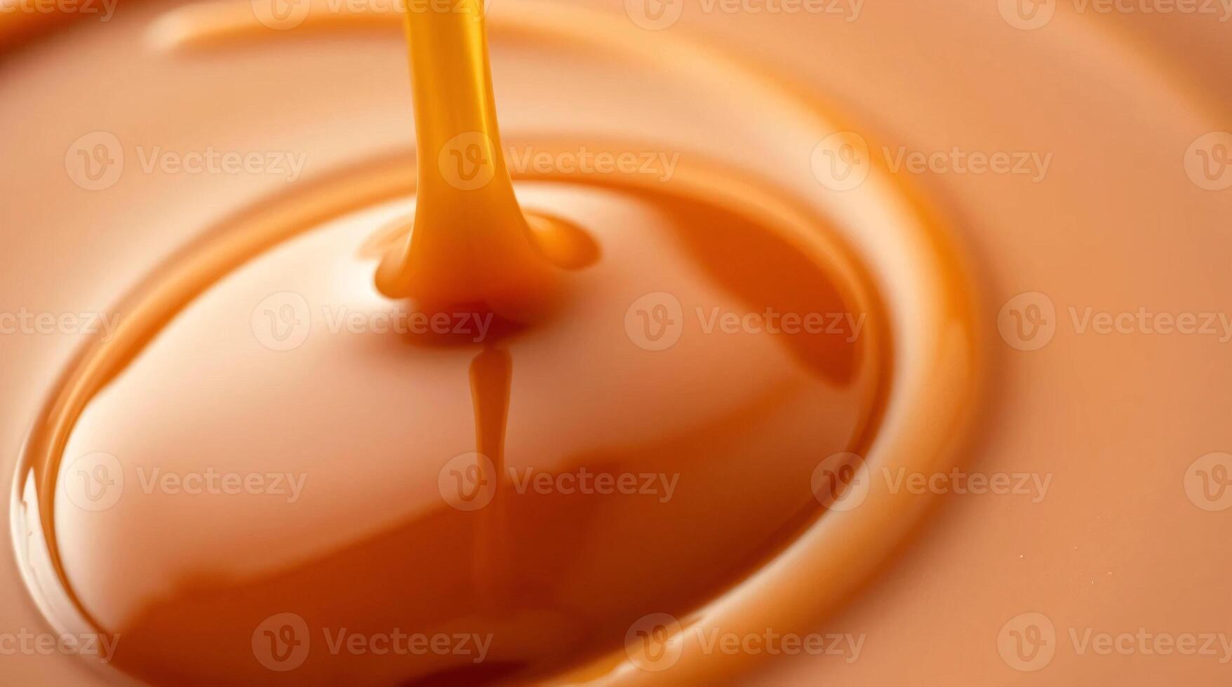 A close up of a caramel sauce being poured into a bowl photo