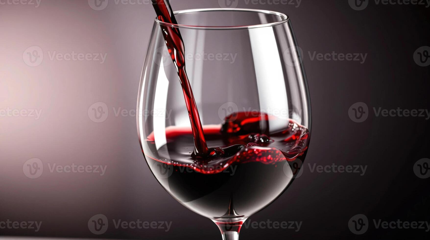 A glass of red wine being poured into it photo