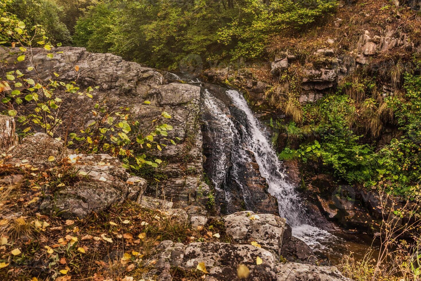 Draganov Vir Waterfall Falling down Rocks in Forest photo