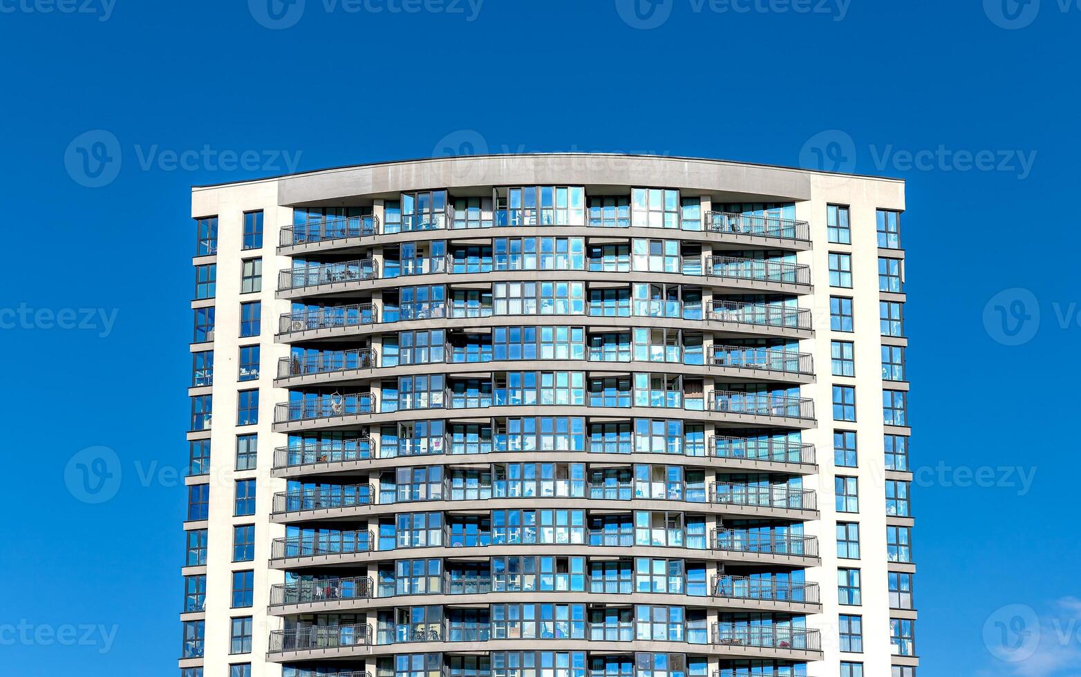 Modern high-rise condominium under development in metropolitan area. Concrete structure with glass photo