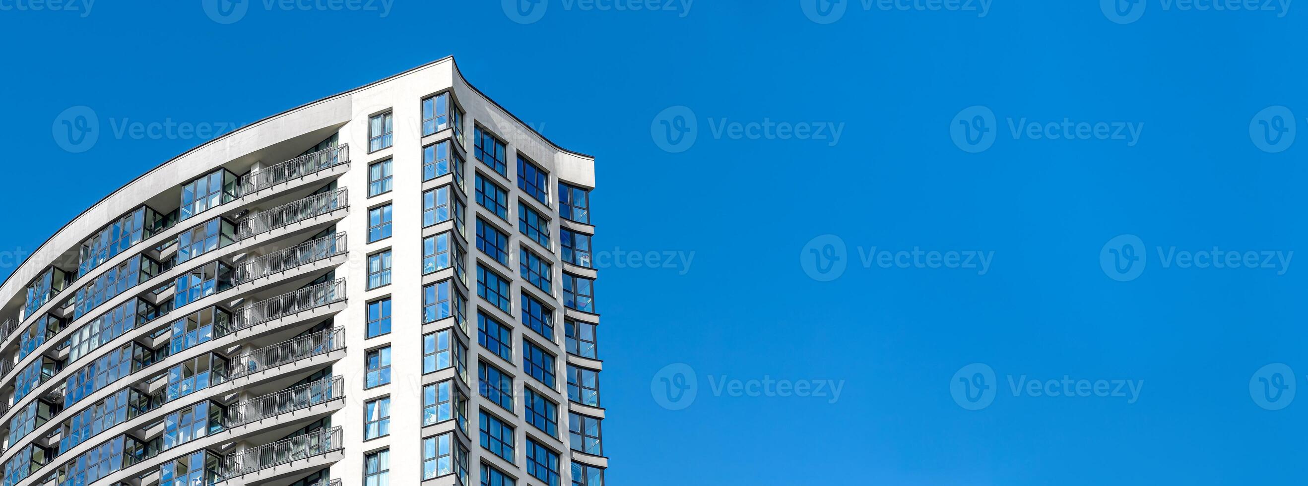 Modern multi-story high-rise building in city, residential property under development. Concrete photo
