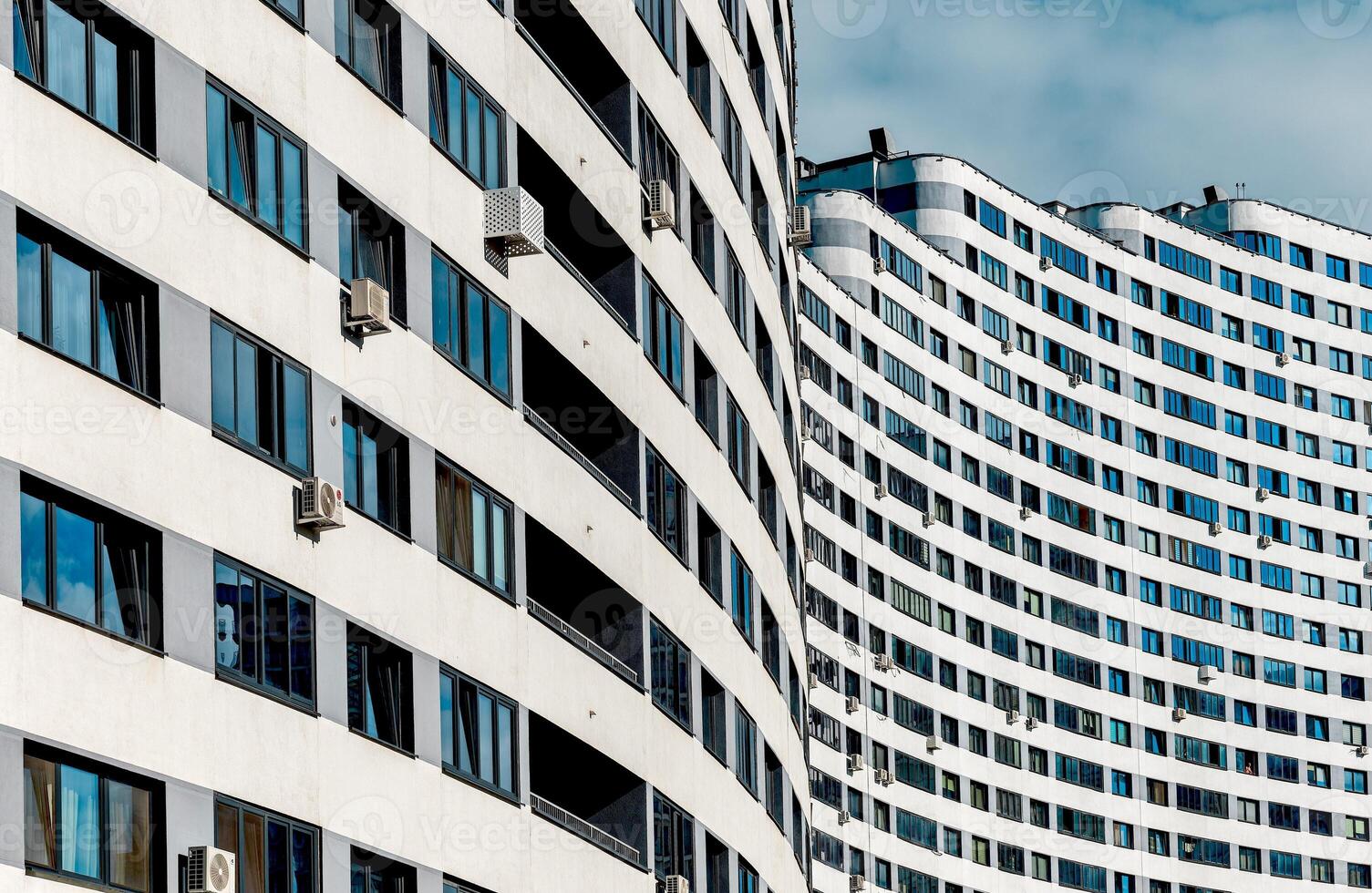 Modern architecture in a developing metropolis. High-rise multistory building with wavy, geometric photo