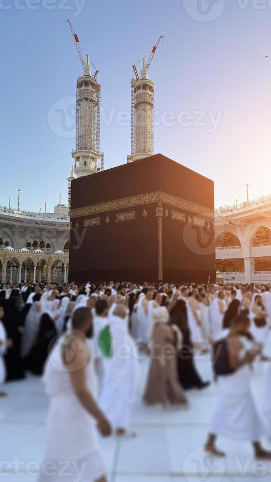 Muslim pilgrims perform Tawaf around the Kaaba after dawn prayer at Masjid al-Haram in Makkah, Saudi Arabia. Muslims worldwide face the Kaaba in prayer, symbolizing unity and devotion in Islam photo
