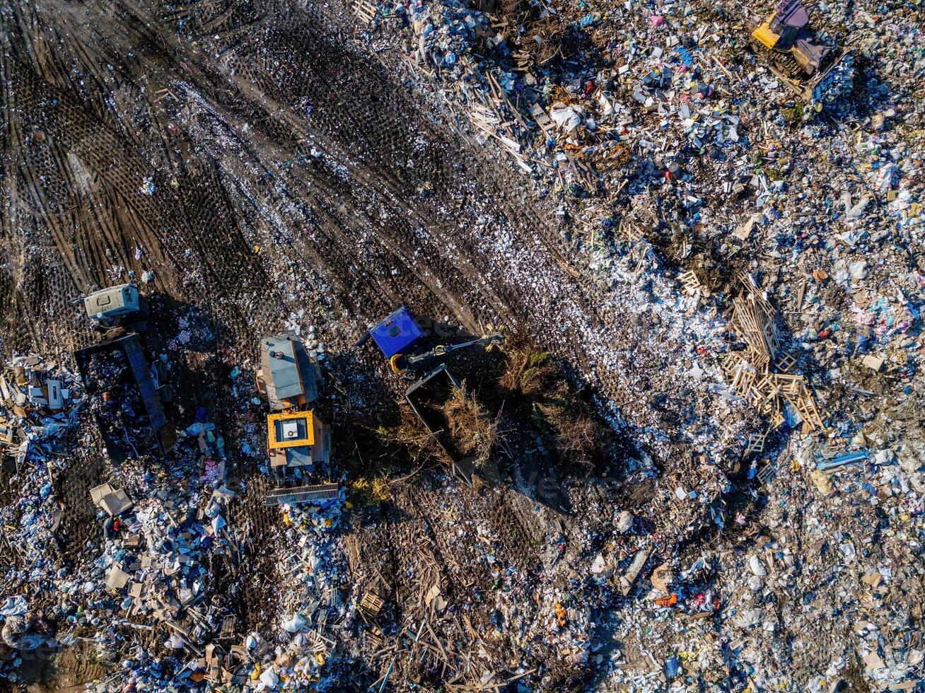 Garbage dump. working dump truck and bulldozer, aerial top view photo