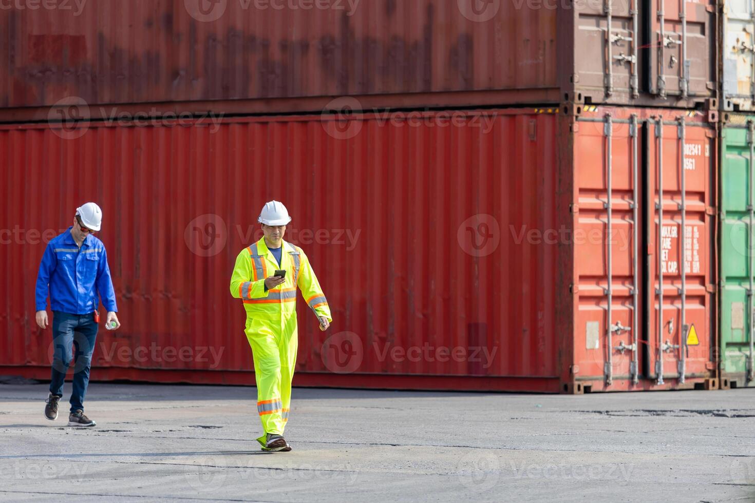 Workers inspecting shipping containers at port, Engineer man walking in industry containers cargo, Foreman dock workers in hardhat at shipping container yard photo