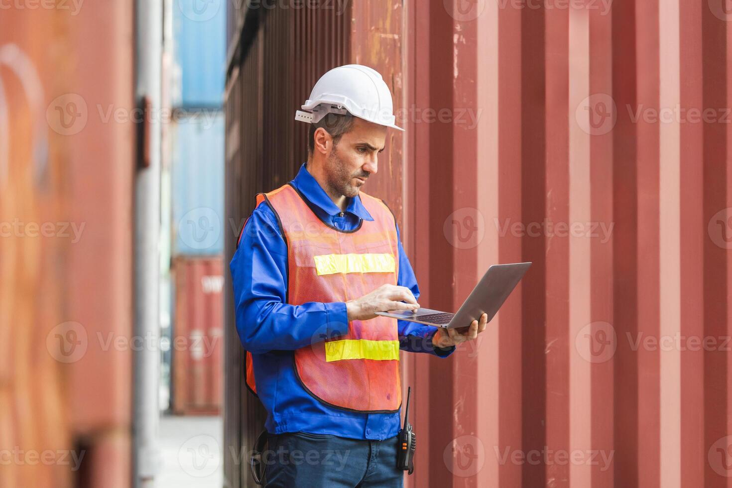 Logistics Professional Inspecting Containers, Engineer Man with Laptop Checking Project in Industry Containers Cargo photo