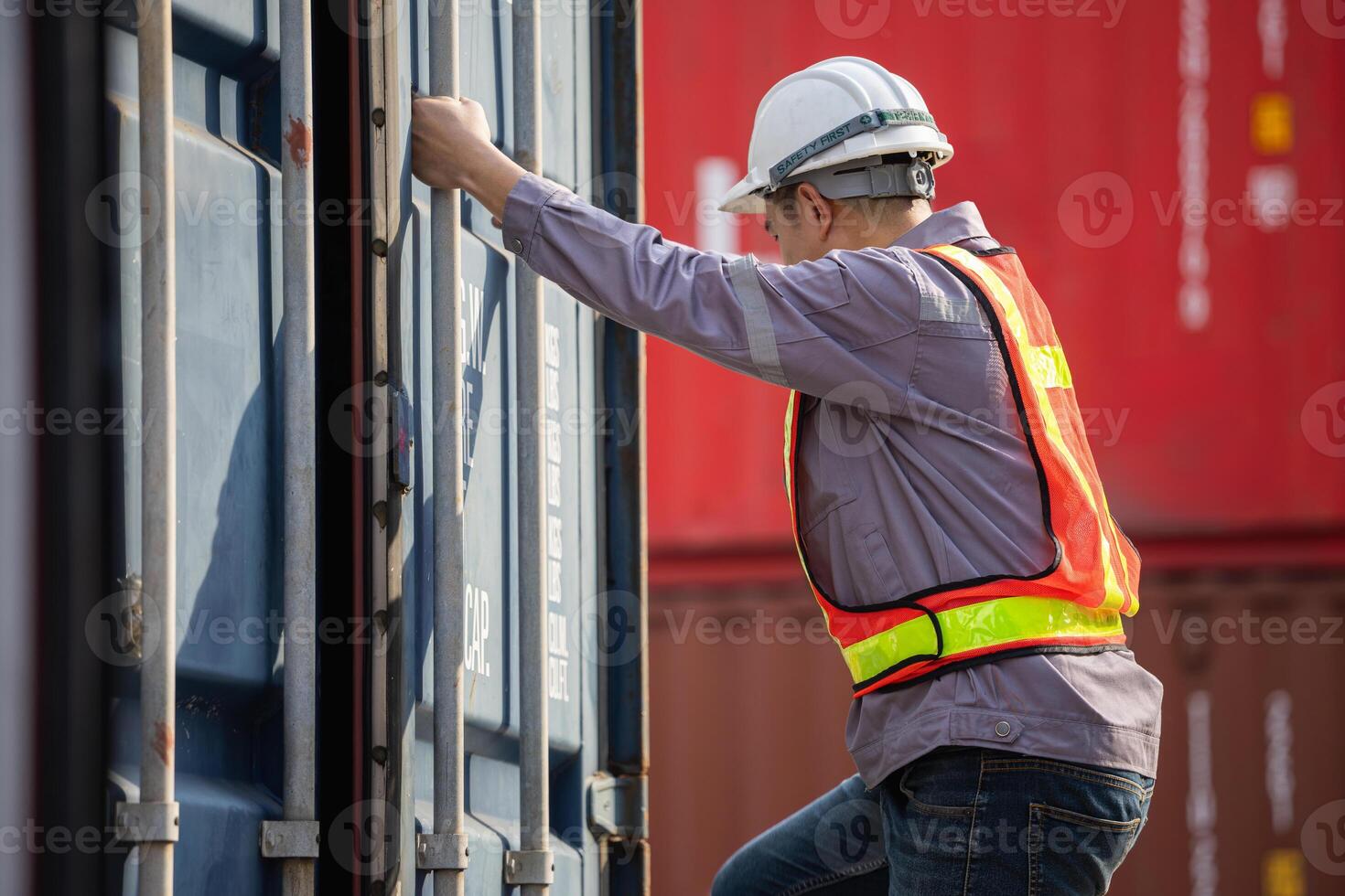 Logistics professional inspecting containers, Engineer man checking containers box in in Industry containers yard photo