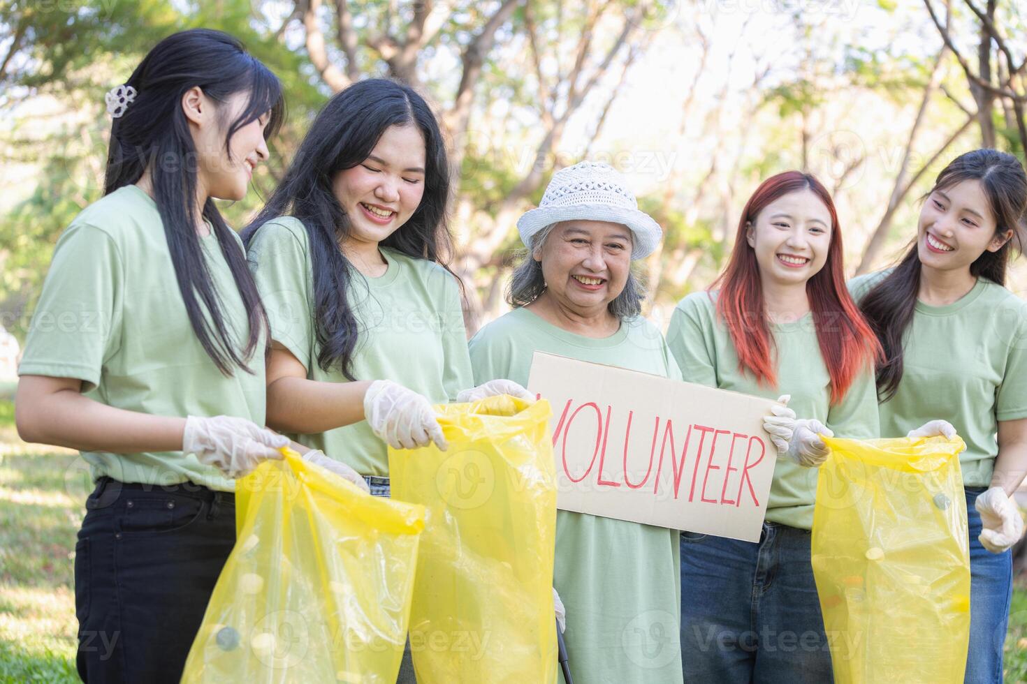 Group of Volunteers Engaged in Cleanup Activity, Eco Volunteers Collecting Plastic Waste in Park, Women Team for a Greener Planet, Female Volunteers Picking Up Trash photo
