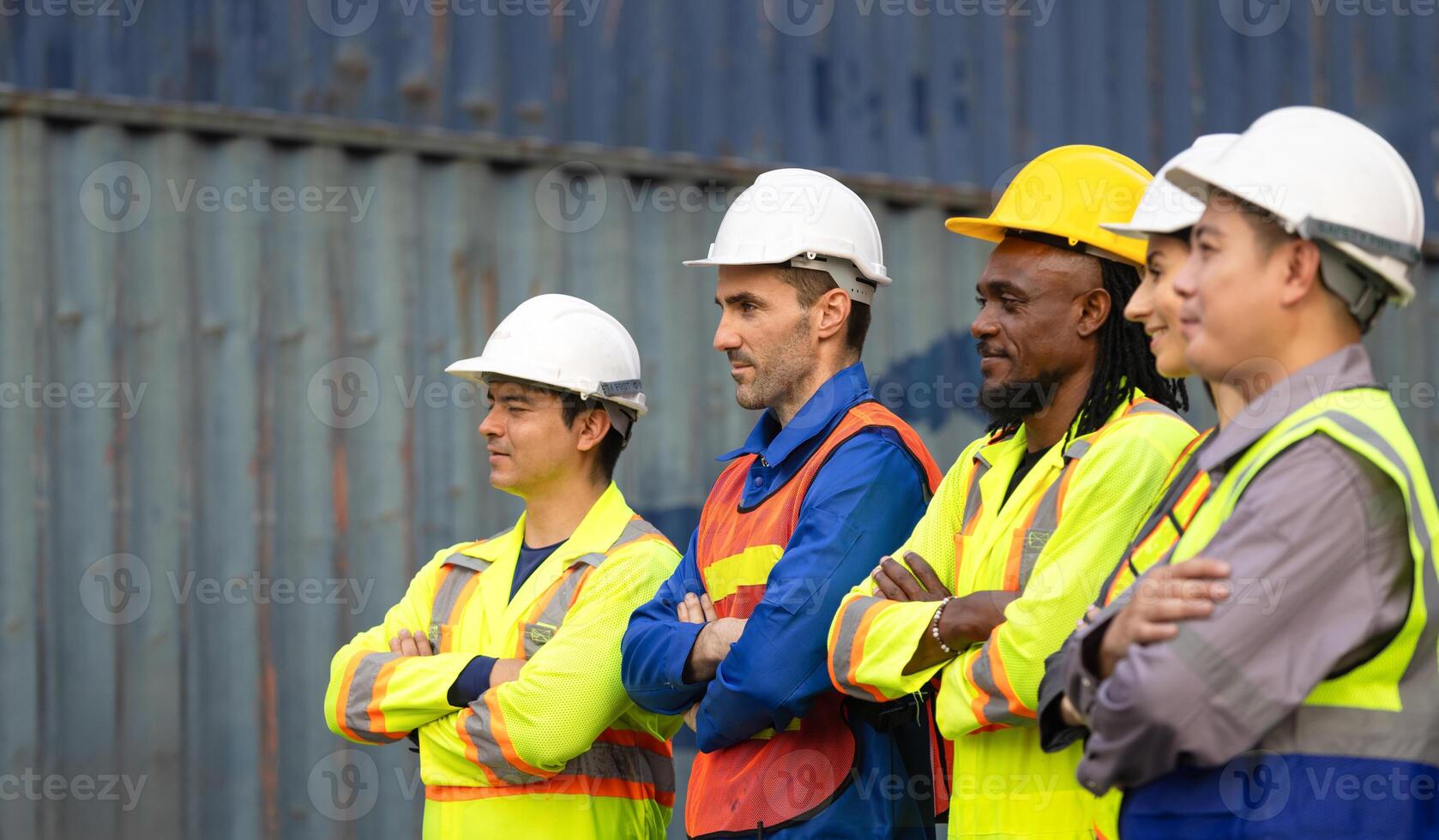 Successful Teamwork in Industrial and Shipping Industry, Diverse Team of Workers Standing With Arms Crossed at Cargo Containers photo