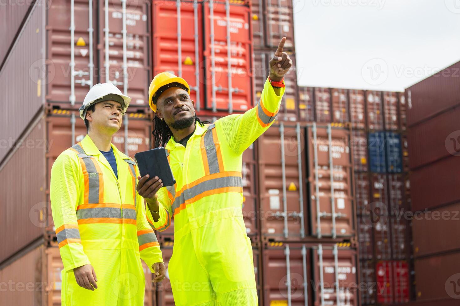 Engineer man Team in Safety Gear Control Containers Box at Industrial Site, Container Yard Workers Discussion in Shipping Yard photo