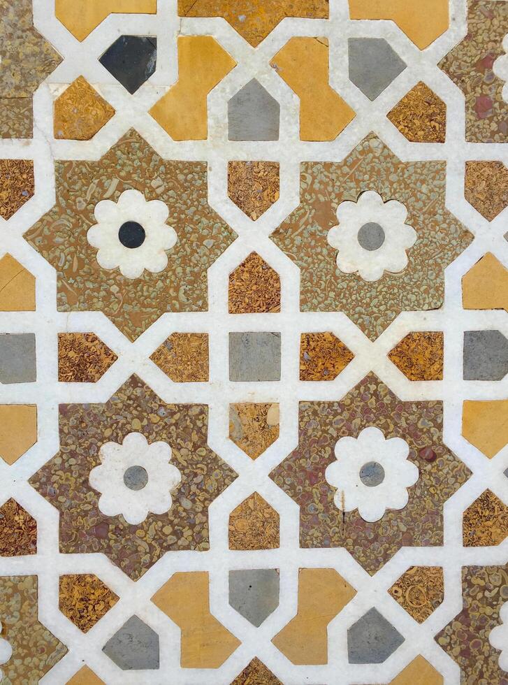 Close up of a patterned tile with flowers photo