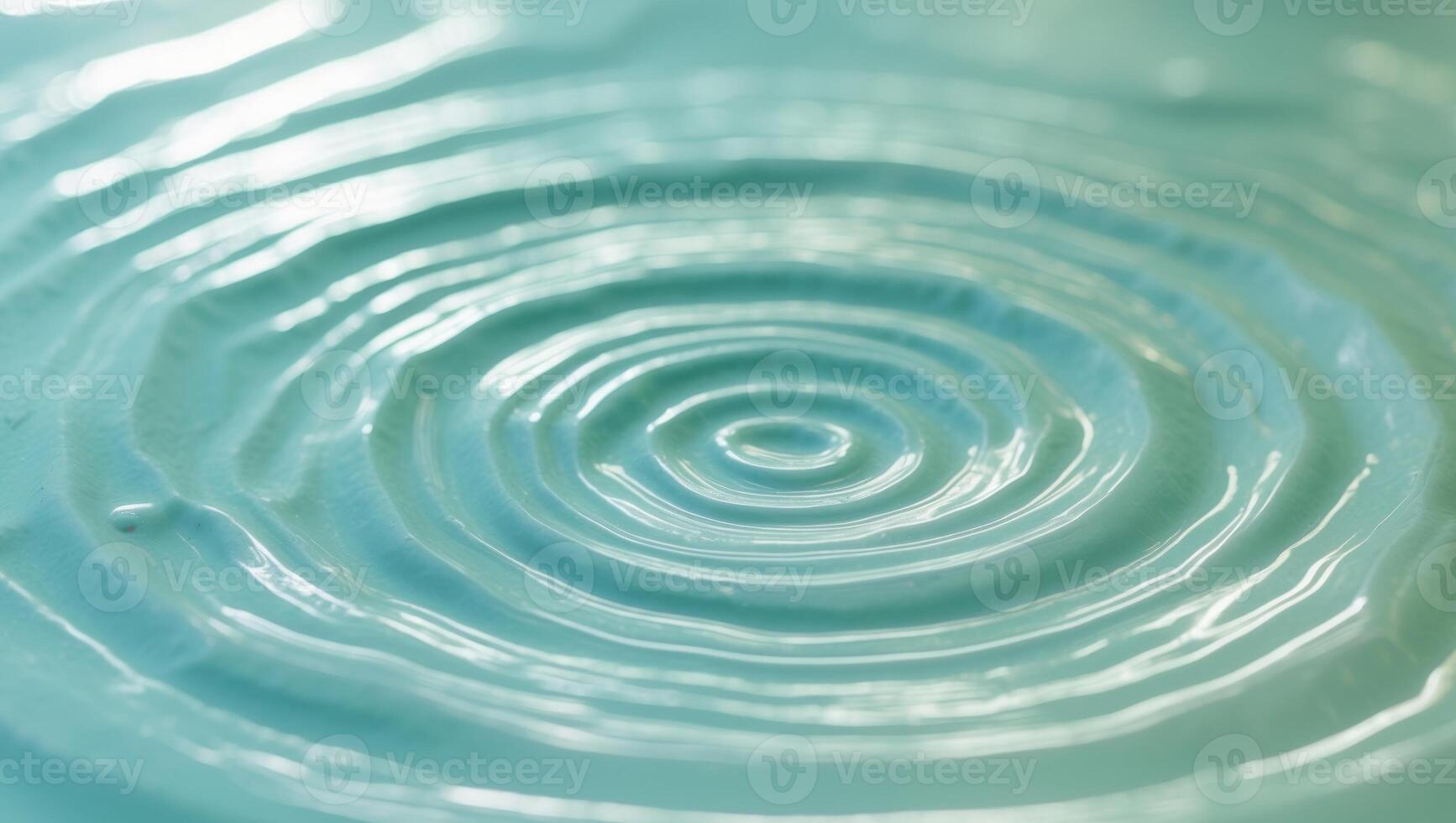 A circular blue liquid with a spiral pattern photo
