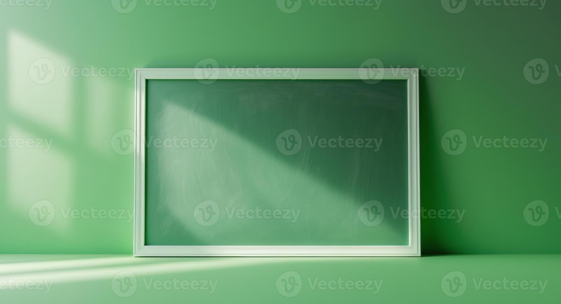 Empty frame on green wall with sunlight photo