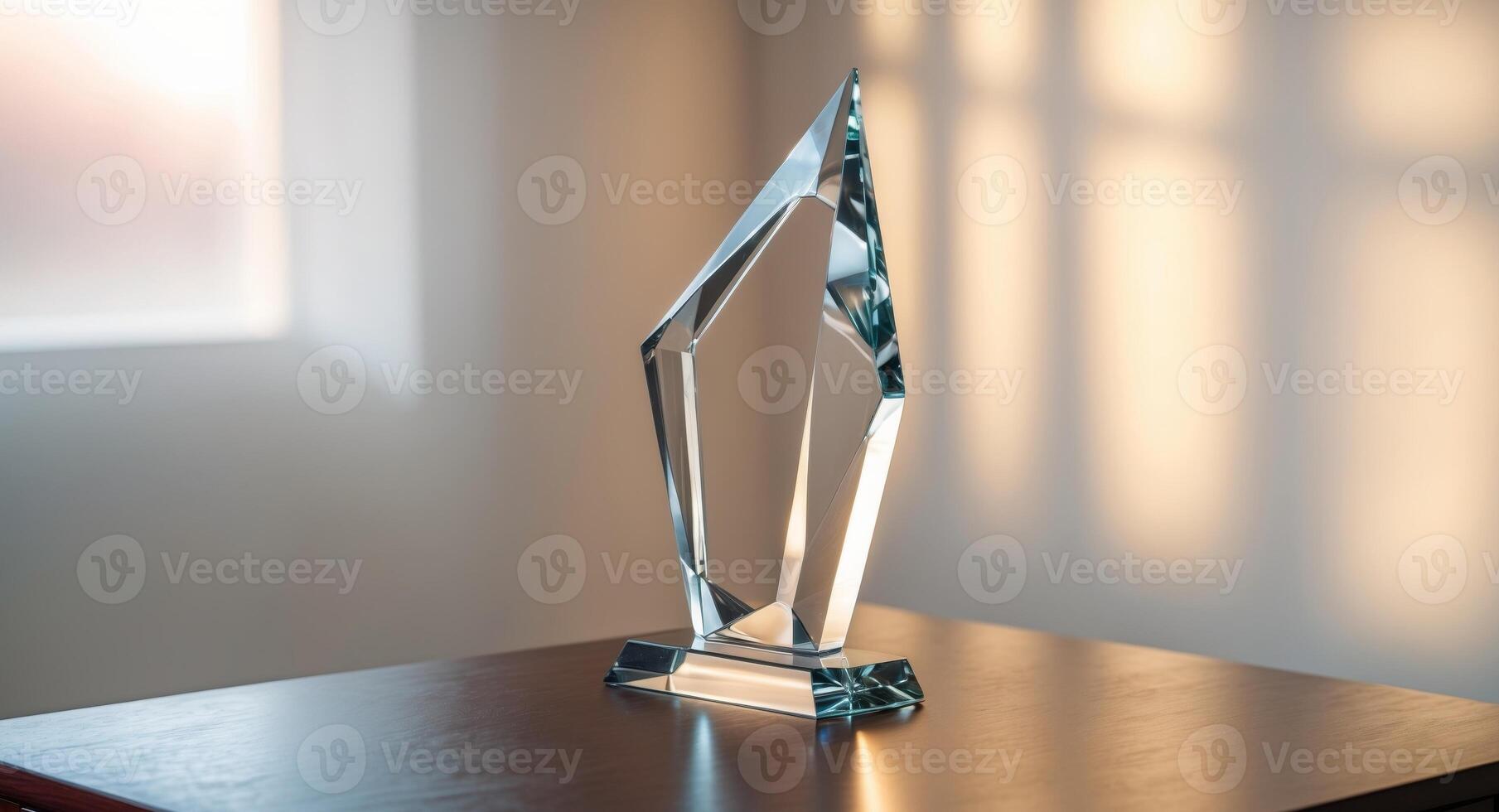 A glass award on a table in front of a window photo