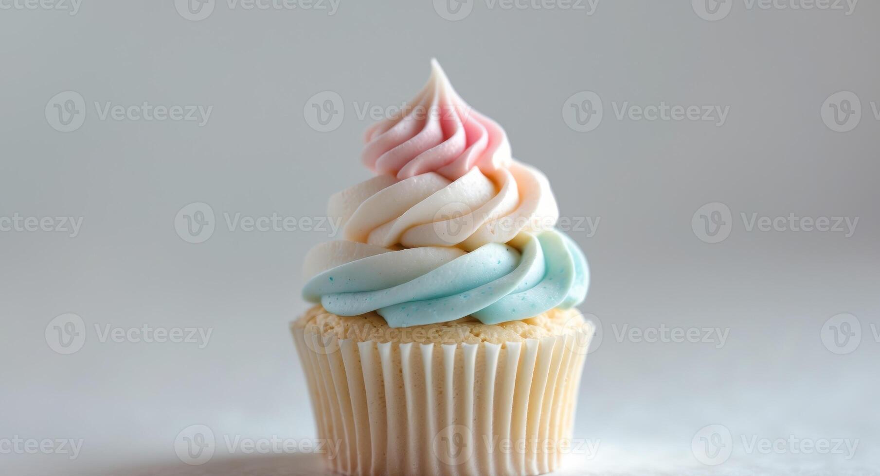 A cupcake with a rainbow frosting on top photo