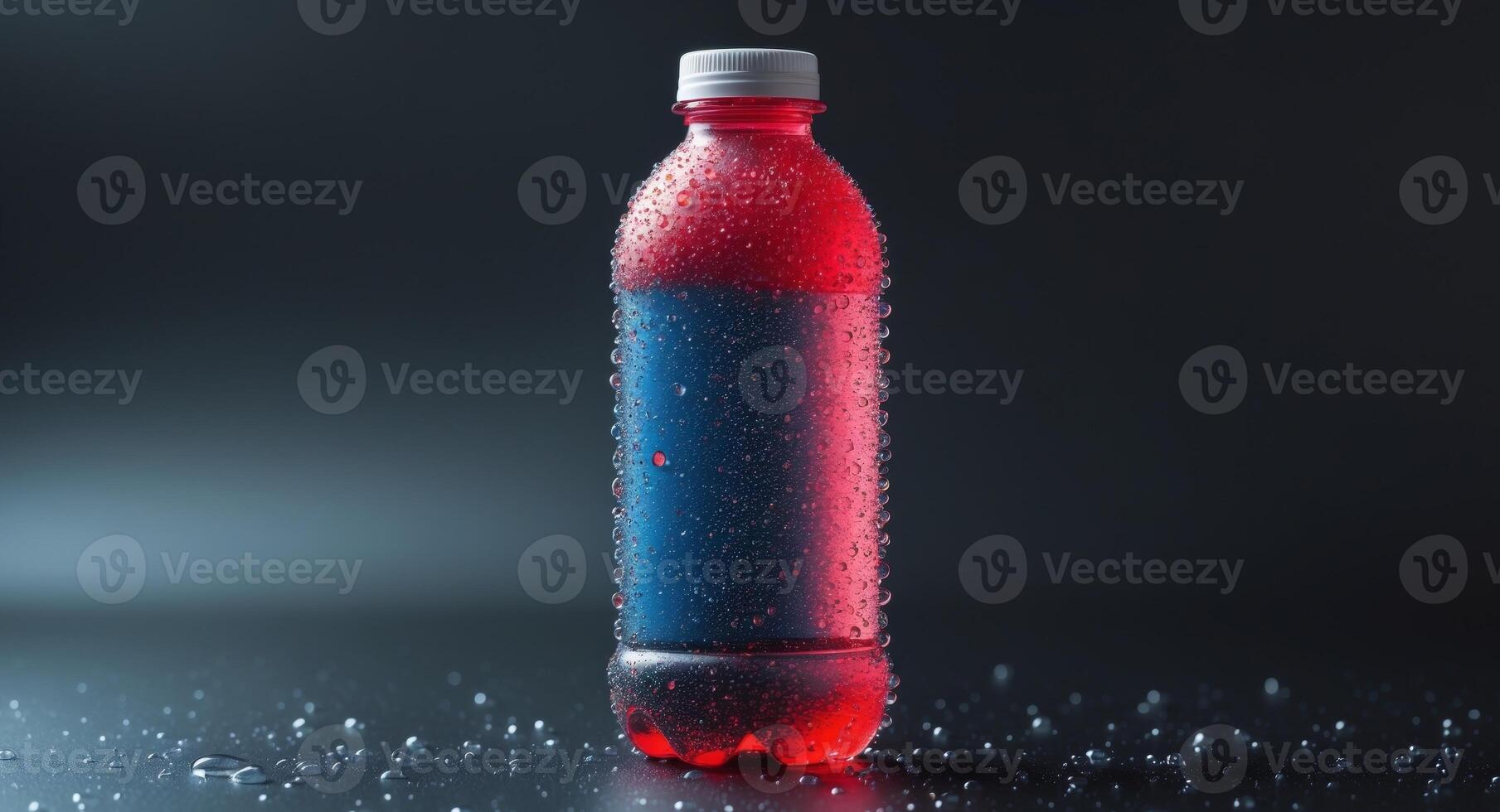 Colorful plastic bottle covered with condensation droplets on dark background. photo