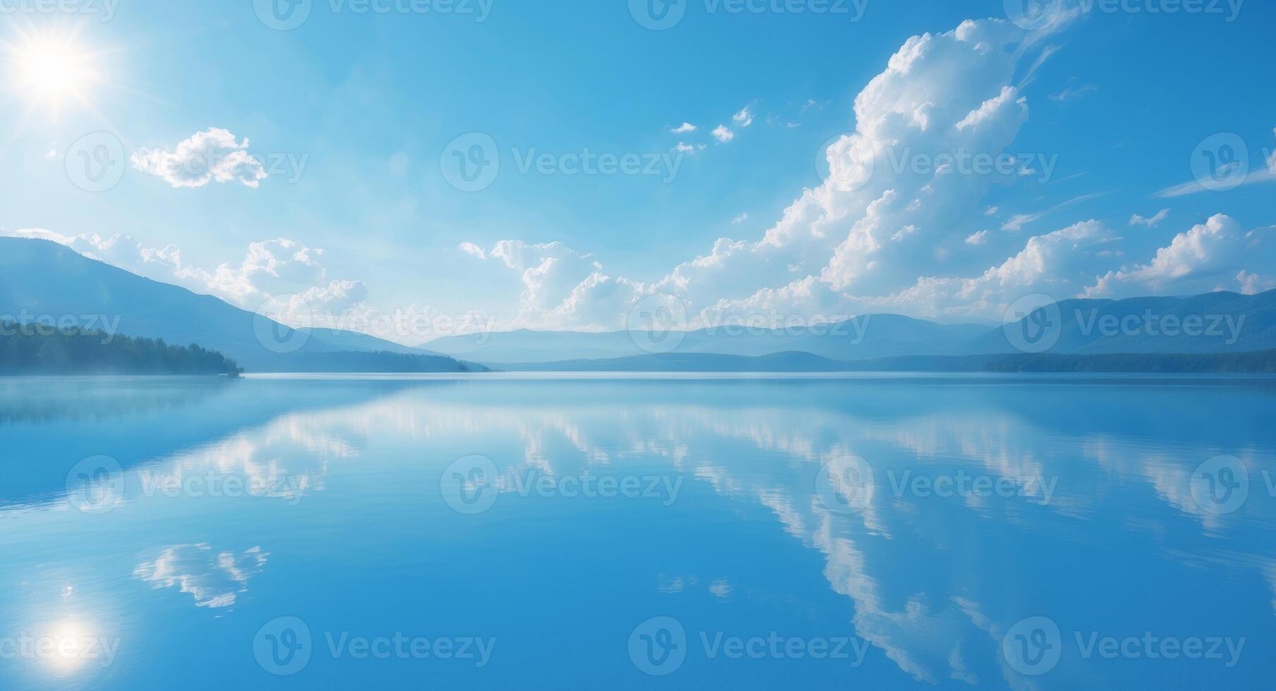 Blue lake with mountains and clouds reflected in the water photo