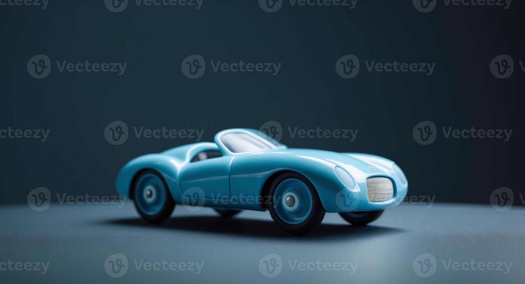 Light blue toy car captures attention on a dark surface with minimal lighting photo