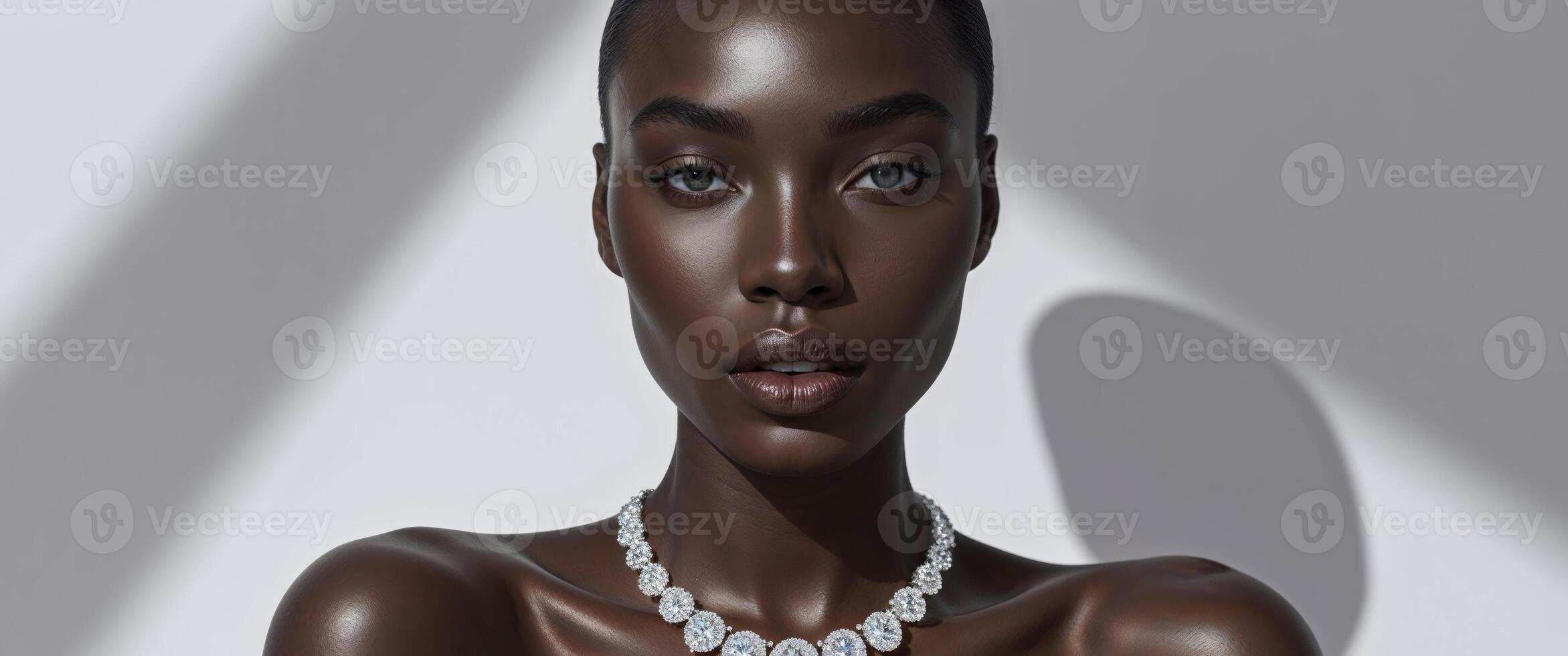 Beautiful black model posing in studio wearing luxury diamond necklace. photo