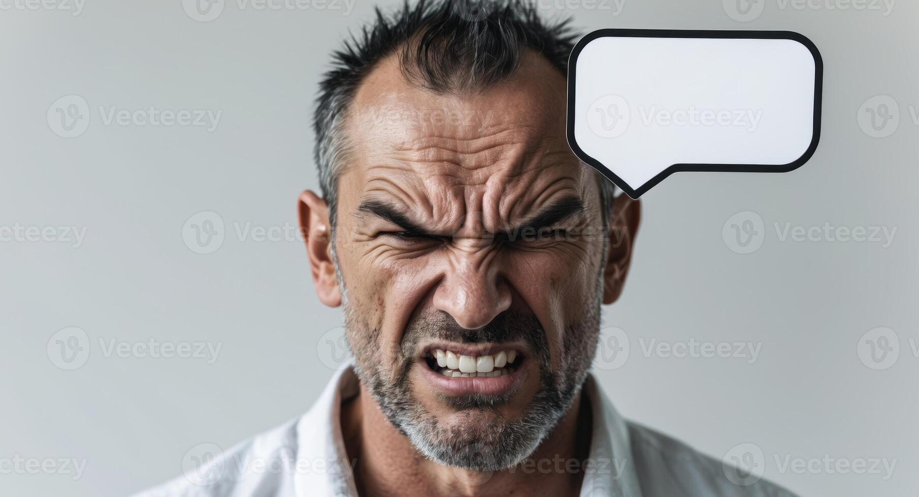 Angry Man Holding Blank Speech Bubble for Message or Announcement. photo