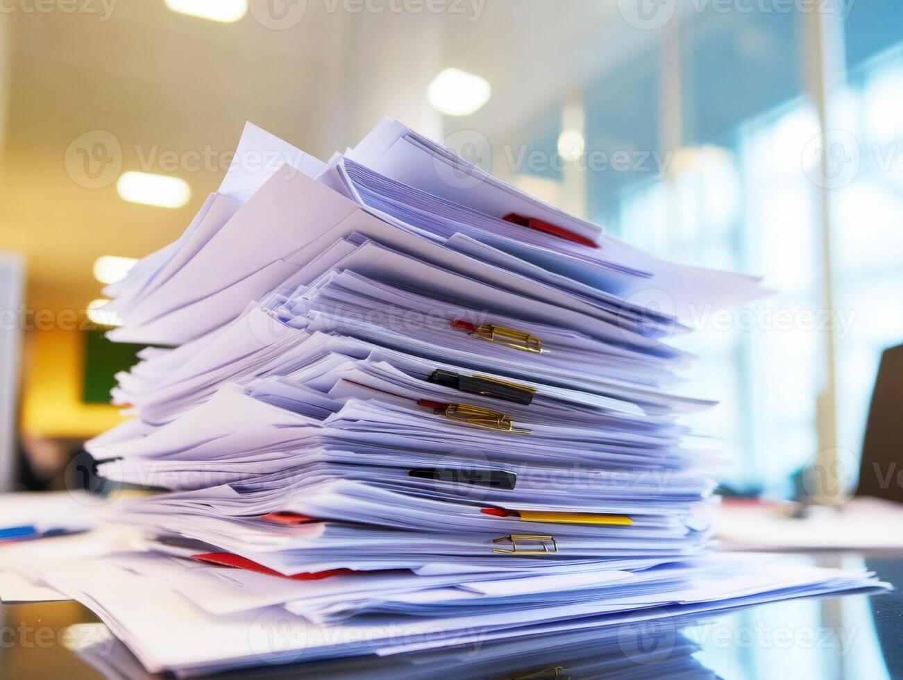 Stacked paperwork creating a cluttered workspace in a modern office photo