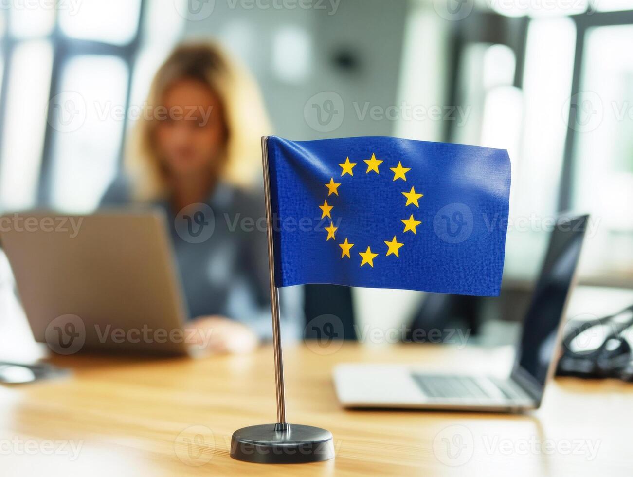 European Union flag displayed on desk in modern office setting photo